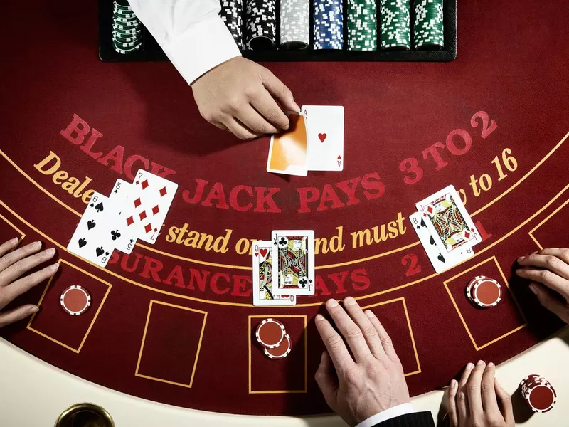 Blackjack game on a red casino table