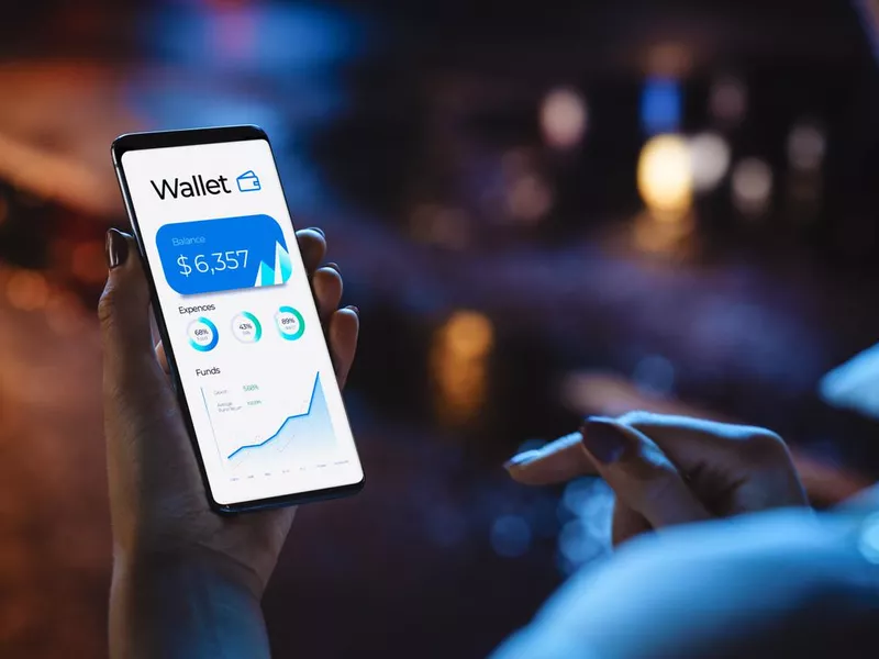 Woman using smartphone to check the balance of her digital wallet